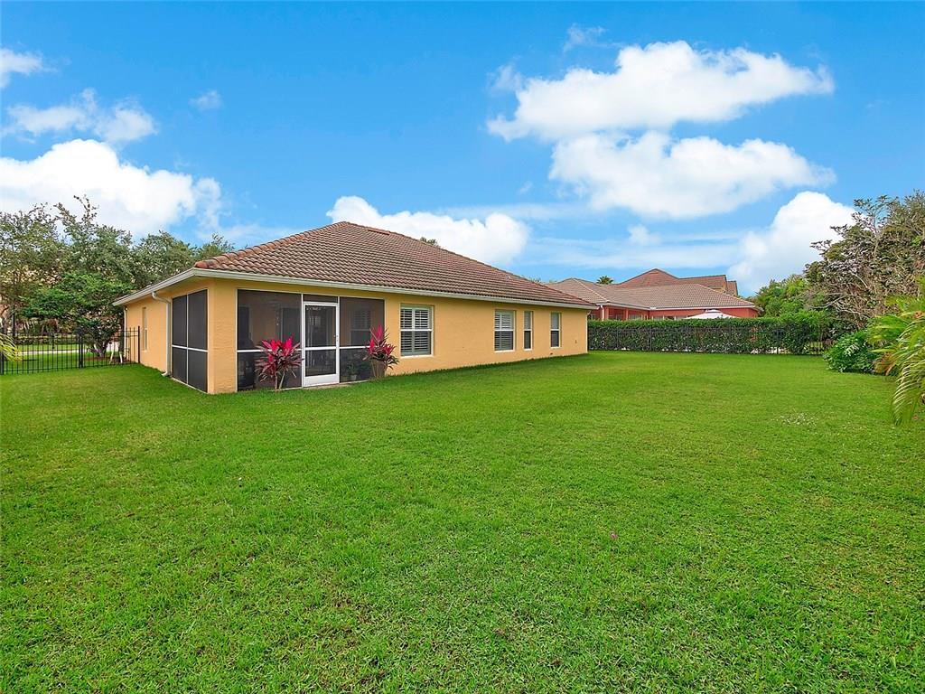 1945 Southwest Panther Trace Stuart, FL 34997 - Photo 17 of 18 a view of a house with a backyard