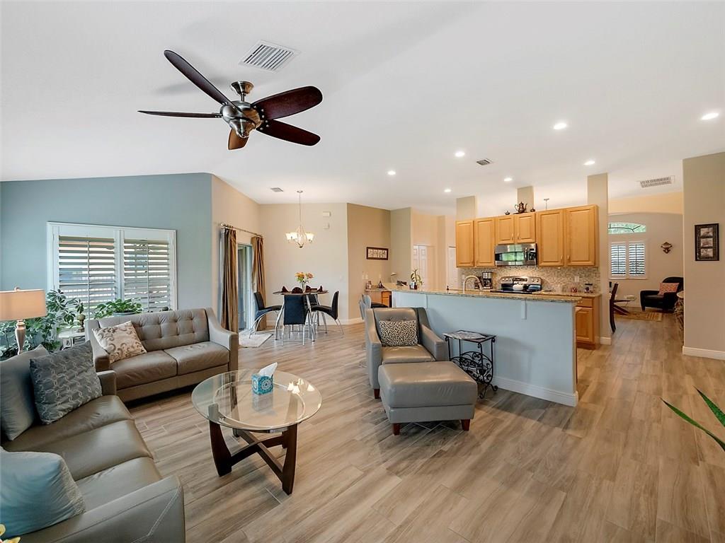 1945 Southwest Panther Trace Stuart, FL 34997 - Photo 6 of 18 a living room with furniture and kitchen view