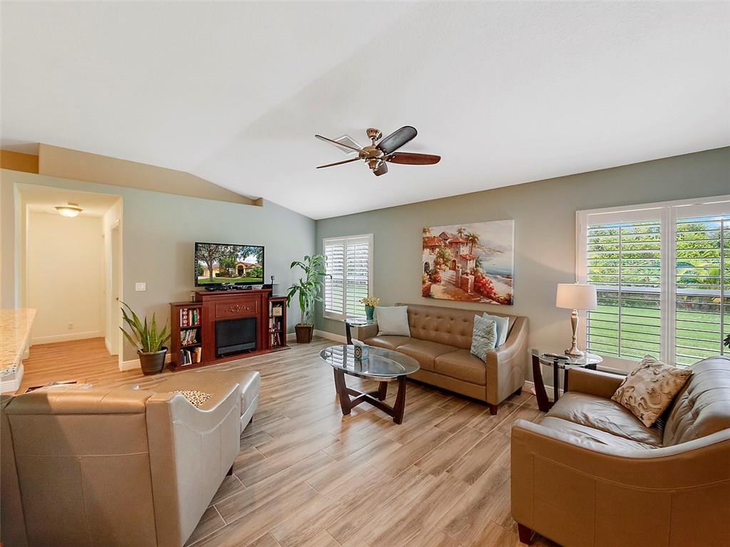 1945 Southwest Panther Trace Stuart, FL 34997 - Photo 7 of 18 a living room with furniture and a large window