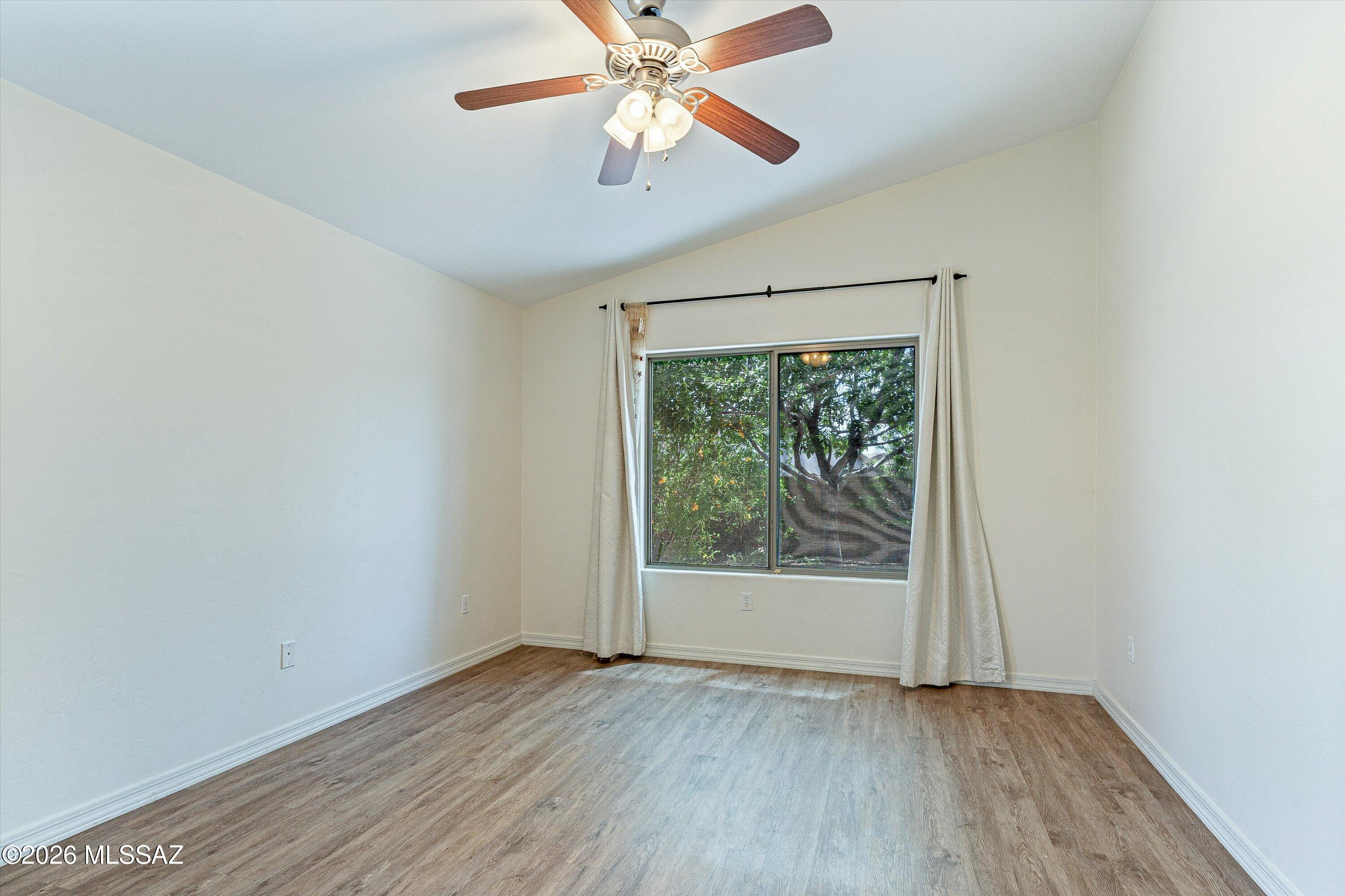 513 South Stone Bench Road Vail, AZ 85641 - Photo 17 of 39 Spacious primary bedroom with ceiling fan and natural light.