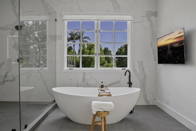 a view of staircase with lots of frames on wall