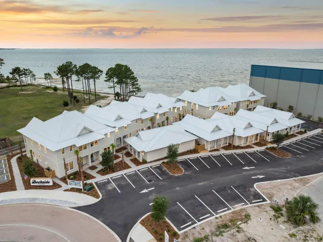 a view of a terrace with lawn chairs