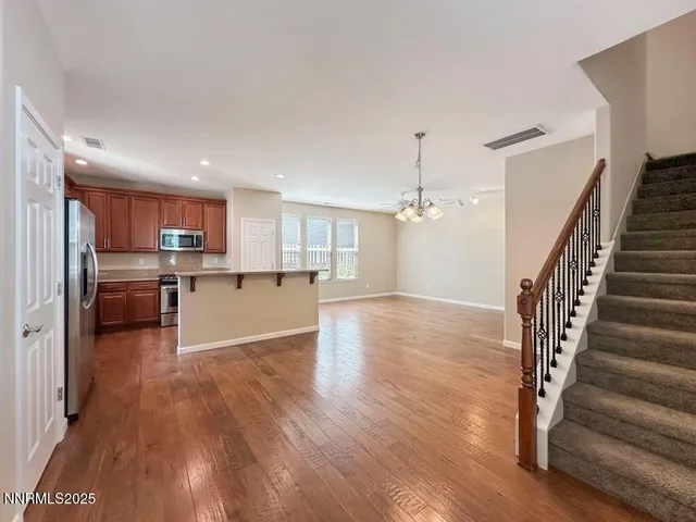 a view of kitchen with wooden floor and electronic appliances