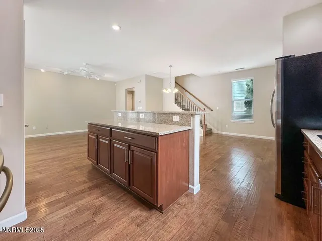 a kitchen with stainless steel appliances granite countertop a stove and a refrigerator
