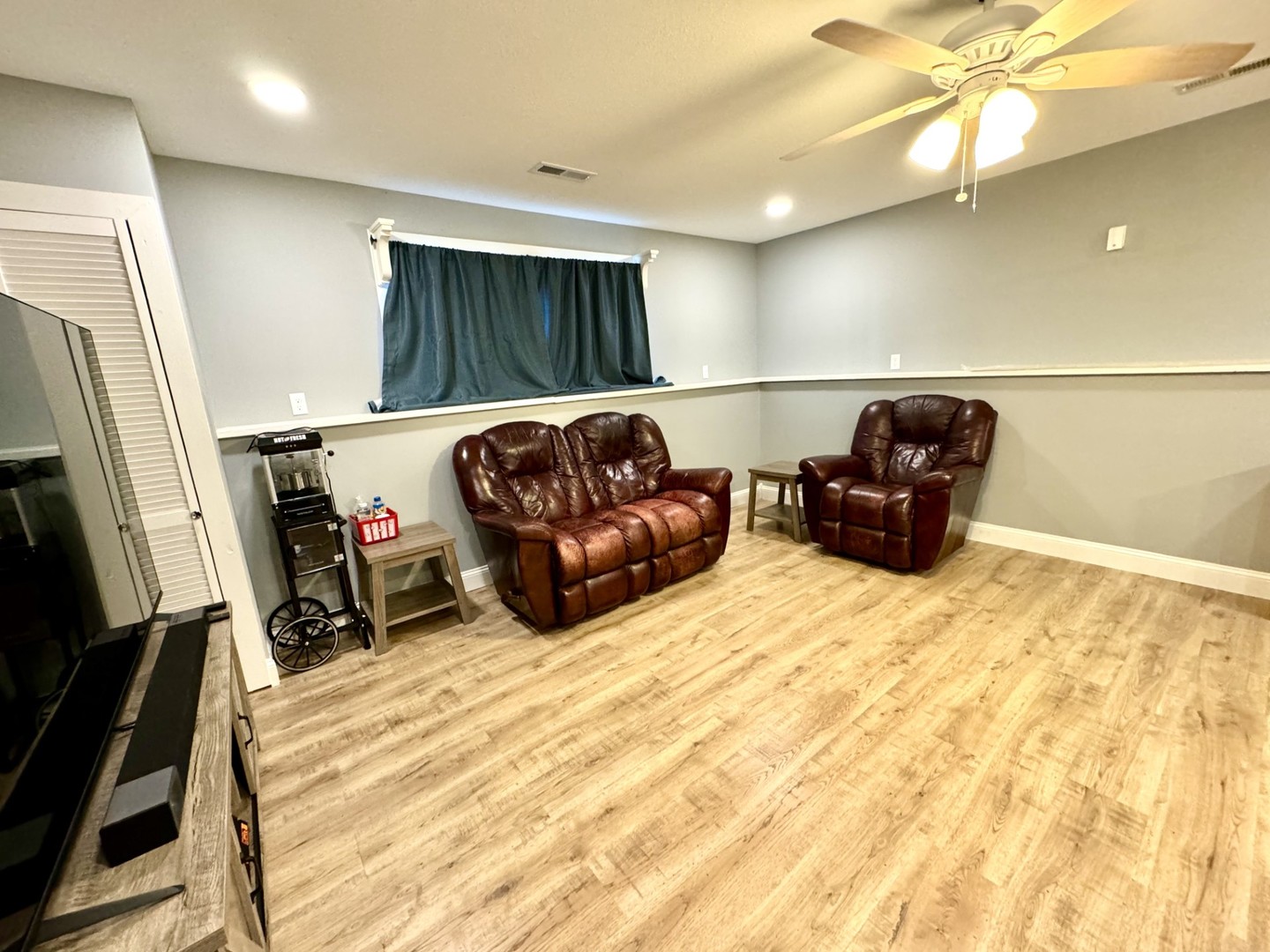 1015 South Maple Street Bloomington, IL 61701 - Photo 14 of 20 a living room with furniture a flat screen tv and a refrigerator