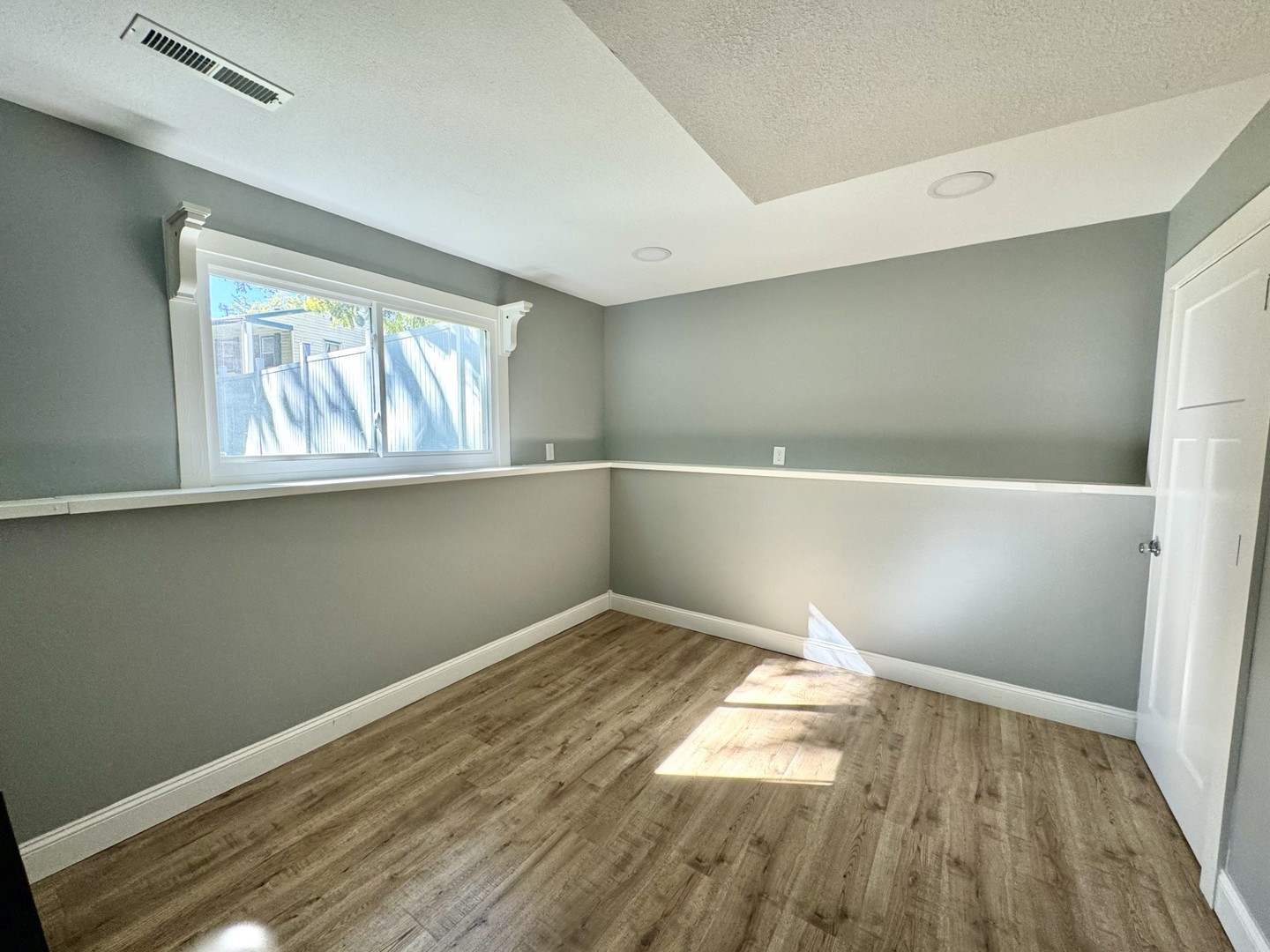 1015 South Maple Street Bloomington, IL 61701 - Photo 16 of 20 a view of empty room with wooden floor and fan