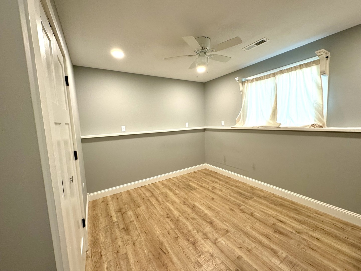 1015 South Maple Street Bloomington, IL 61701 - Photo 17 of 20 a view of a big room with wooden floor and windows