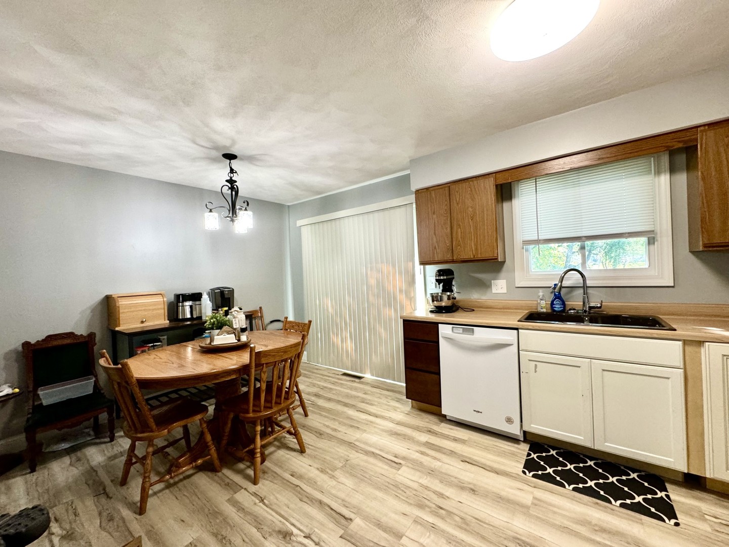 1015 South Maple Street Bloomington, IL 61701 - Photo 7 of 20 a kitchen with a dining table chairs and white cabinets