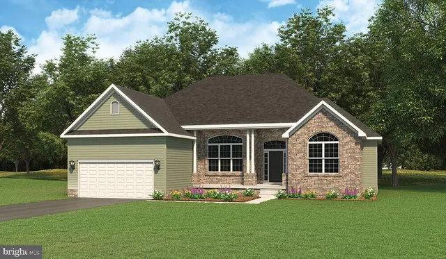 a front view of a house with a garden and yard