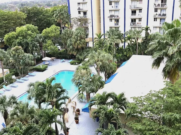 a view of a multi story building with a yard