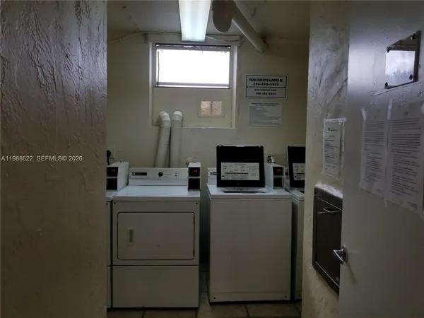 a view of storage and utility room with washer and dryer