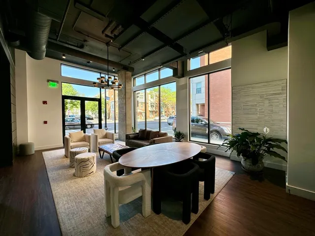 a dining room with furniture window and wooden floor