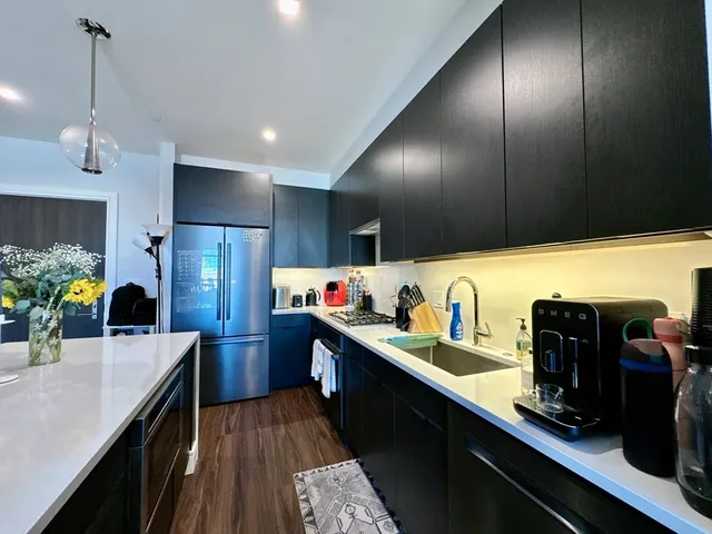 a kitchen with sink cabinets and refrigerator