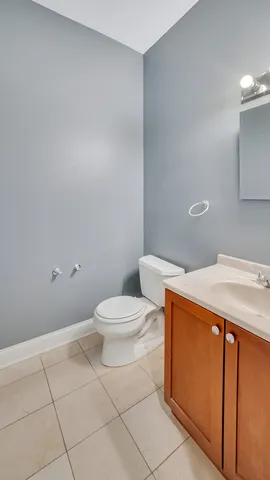 a white toilet sitting next to a bathroom sink