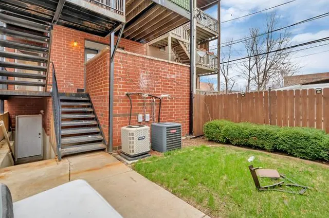 a backyard of a house with a garden and plants