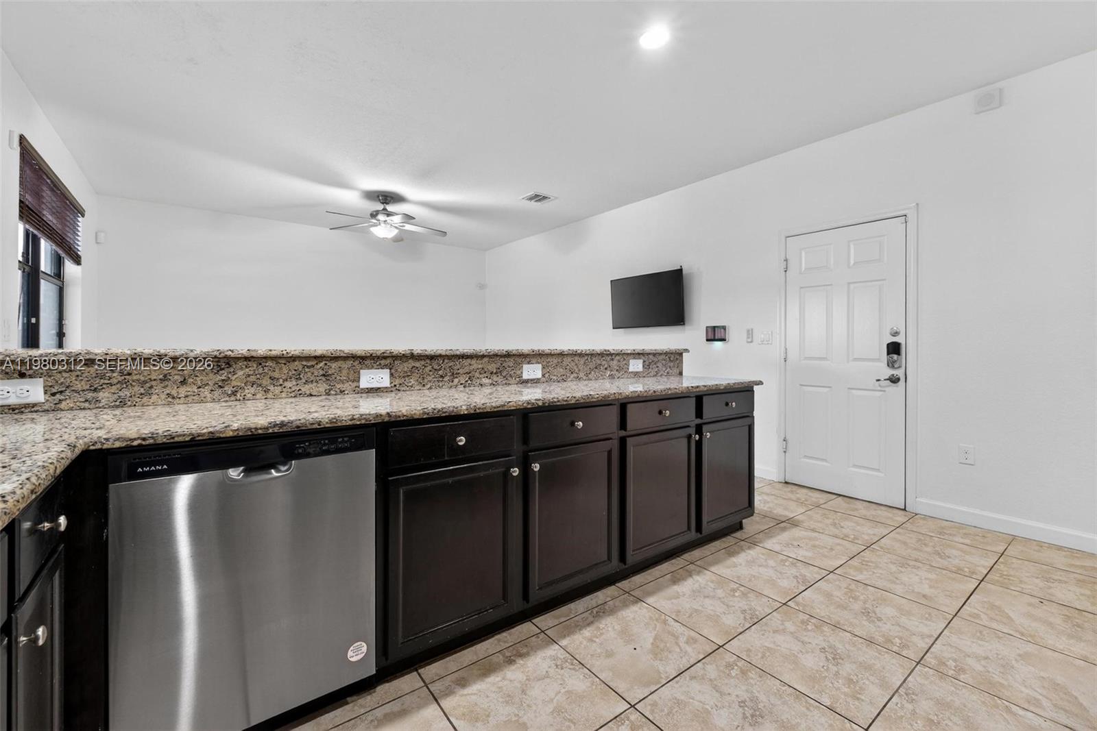 11561 Southwest 232nd Lane, Unit 11561 Homestead, FL 33032 - Photo 16 of 61 a kitchen with a sink a refrigerator and cabinets
