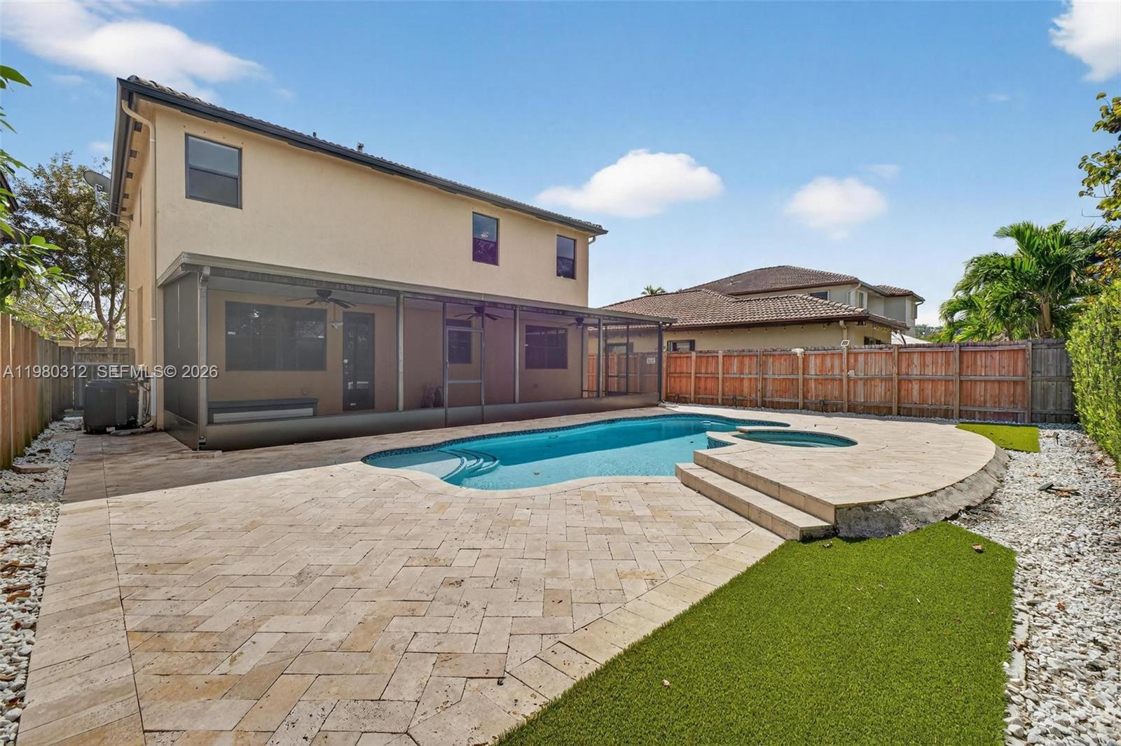 11561 Southwest 232nd Lane, Unit 11561 Homestead, FL 33032 - Photo 23 of 61 a view of a backyard with a barbeque grill and plants