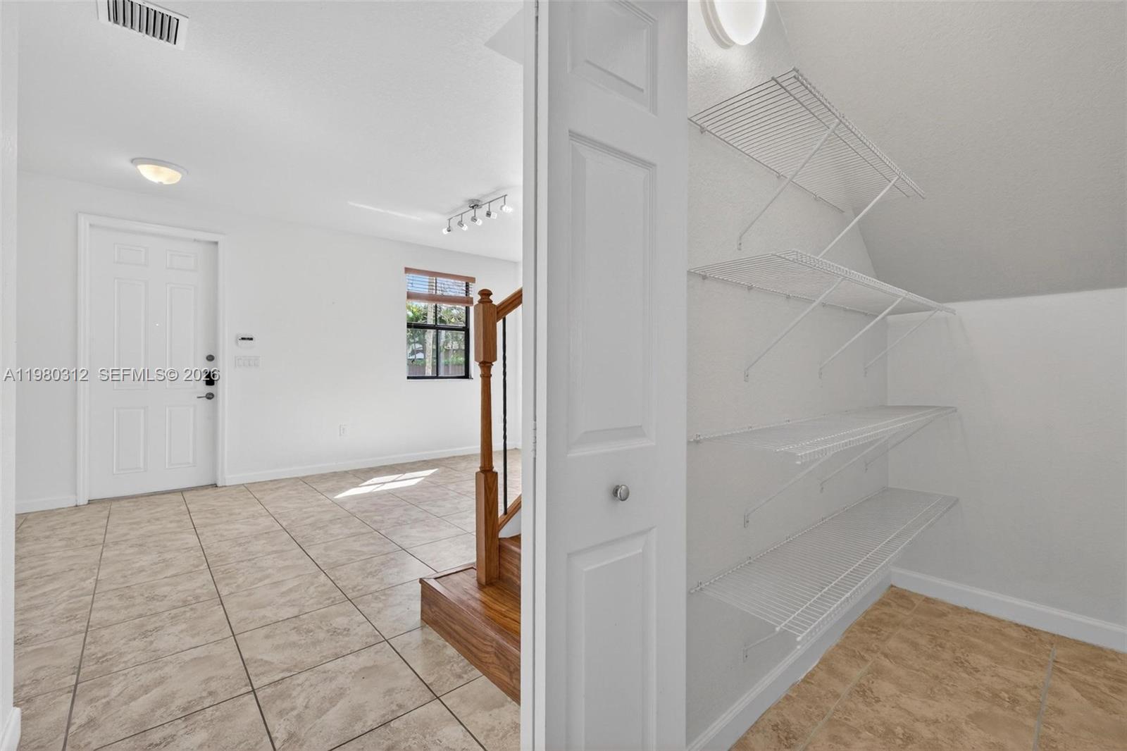 11561 Southwest 232nd Lane, Unit 11561 Homestead, FL 33032 - Photo 26 of 61 a view of an empty walk in closet