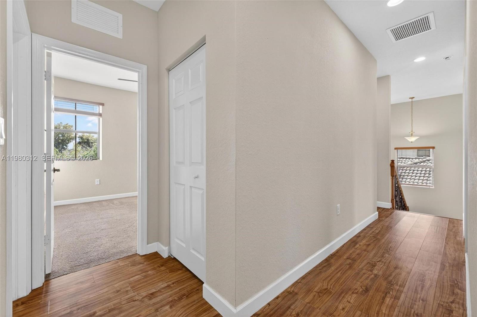 11561 Southwest 232nd Lane, Unit 11561 Homestead, FL 33032 - Photo 28 of 61 a view of hallway with wooden floor