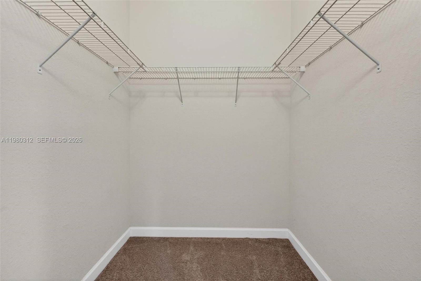 11561 Southwest 232nd Lane, Unit 11561 Homestead, FL 33032 - Photo 32 of 61 a view of a room with racks on the wall