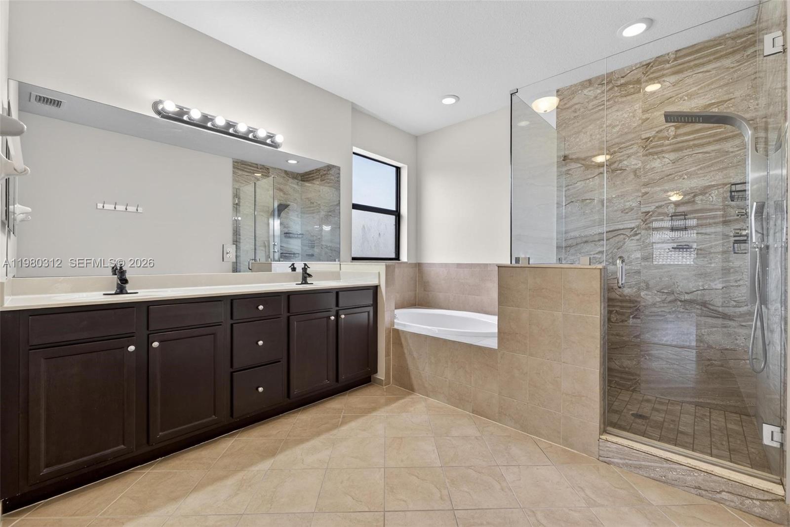 11561 Southwest 232nd Lane, Unit 11561 Homestead, FL 33032 - Photo 33 of 61 a spacious bathroom with a tub sink shower and mirror