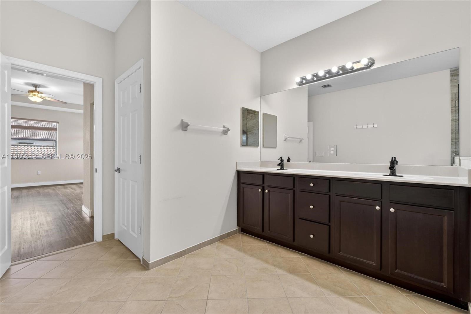 11561 Southwest 232nd Lane, Unit 11561 Homestead, FL 33032 - Photo 34 of 61 a bathroom with a tub sink and mirror
