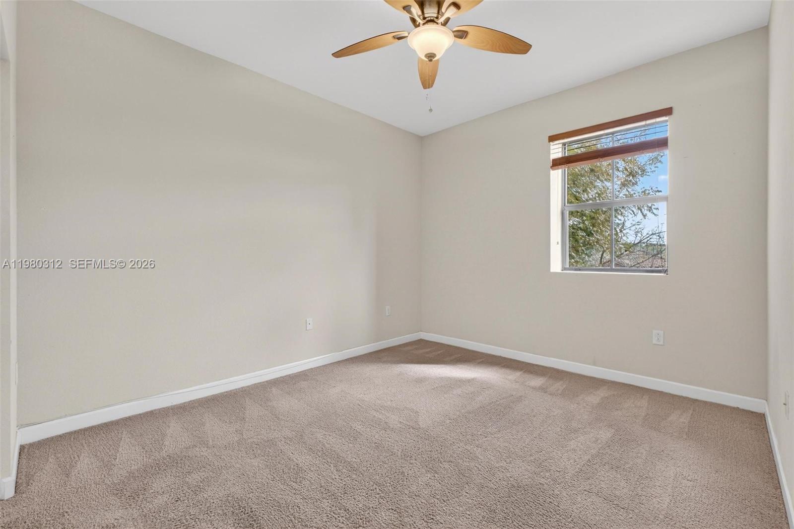 11561 Southwest 232nd Lane, Unit 11561 Homestead, FL 33032 - Photo 37 of 61 an empty room with a window