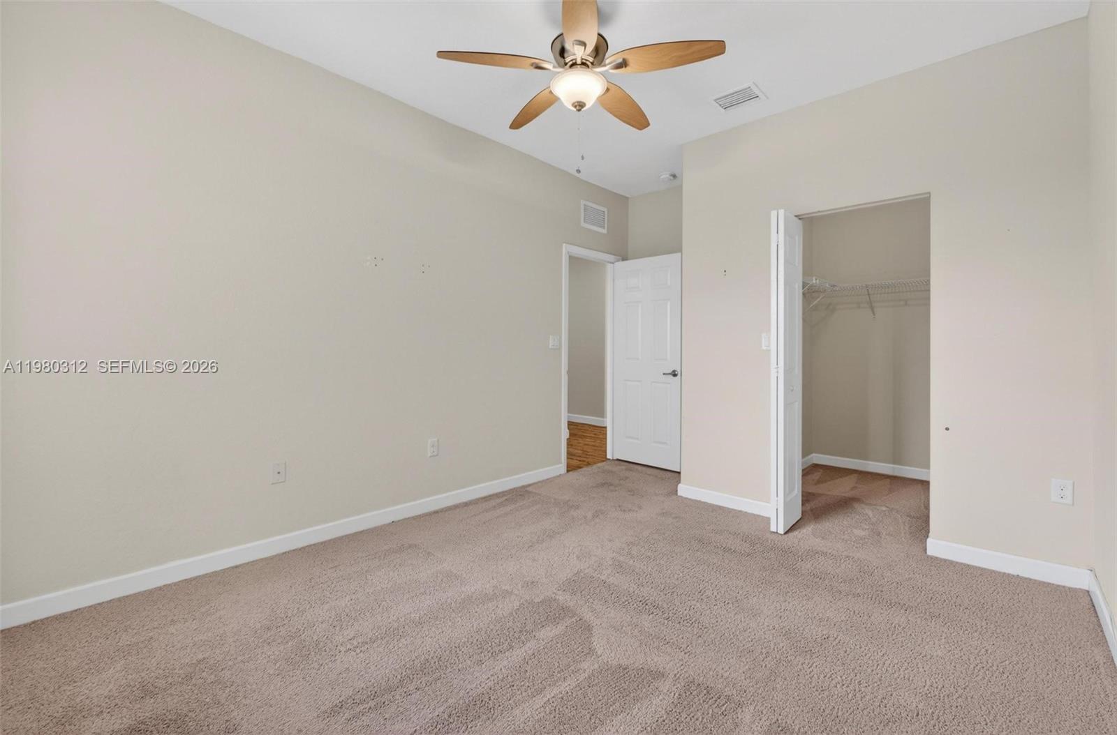 11561 Southwest 232nd Lane, Unit 11561 Homestead, FL 33032 - Photo 38 of 61 an empty room with chandelier fan