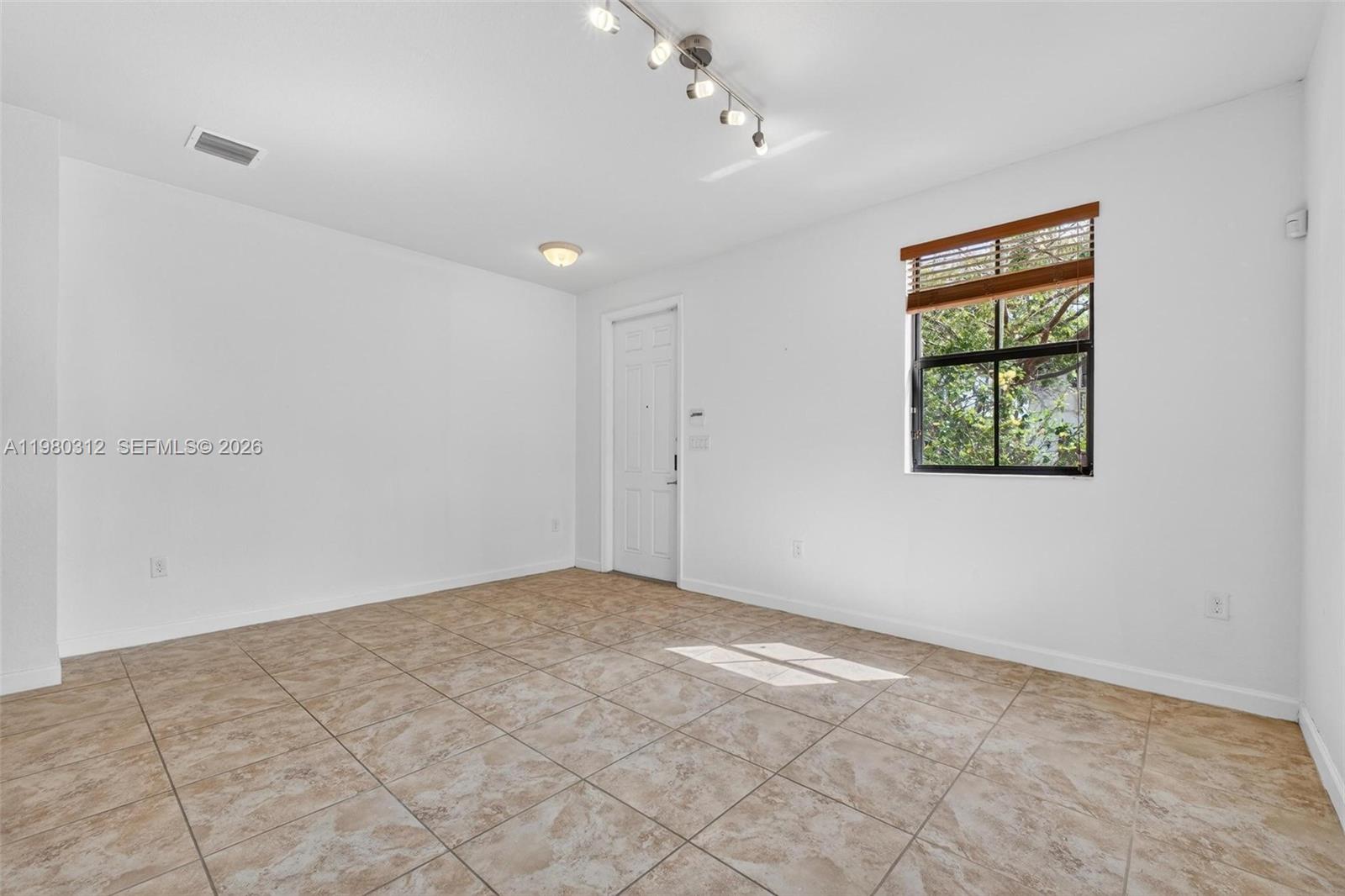 11561 Southwest 232nd Lane, Unit 11561 Homestead, FL 33032 - Photo 4 of 61 a view of room with window and ceiling fan