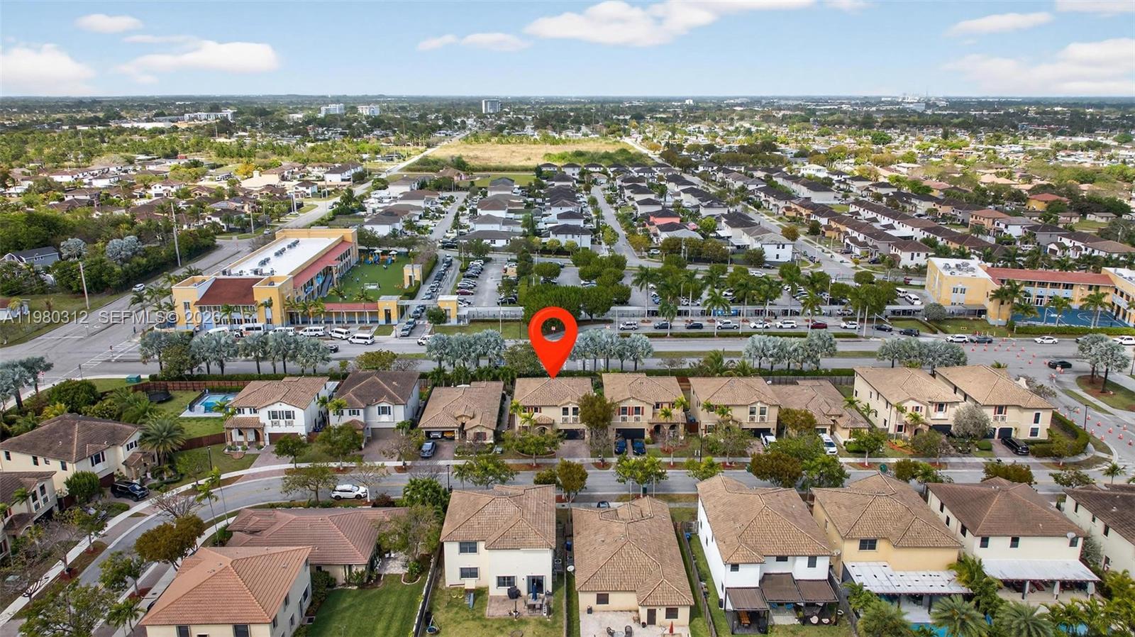 11561 Southwest 232nd Lane, Unit 11561 Homestead, FL 33032 - Photo 48 of 61 an aerial view of a city with lots of residential buildings ocean and mountain view in back