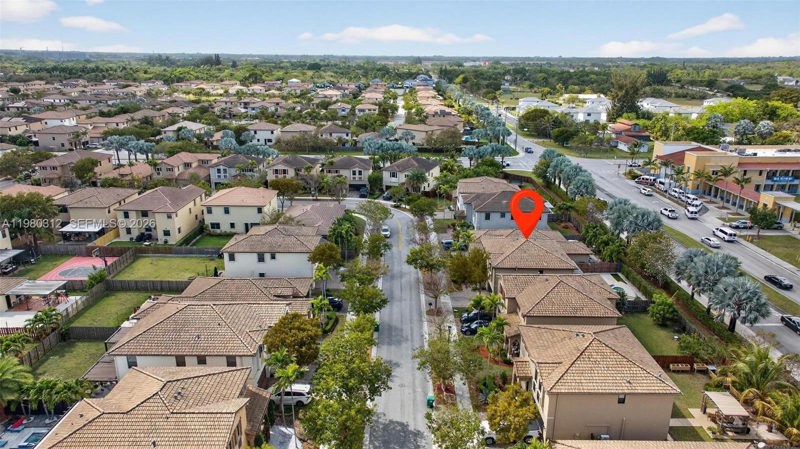 11561 Southwest 232nd Lane, Unit 11561 Homestead, FL 33032 - Photo 53 of 61 an aerial view of residential houses with outdoor space and trees
