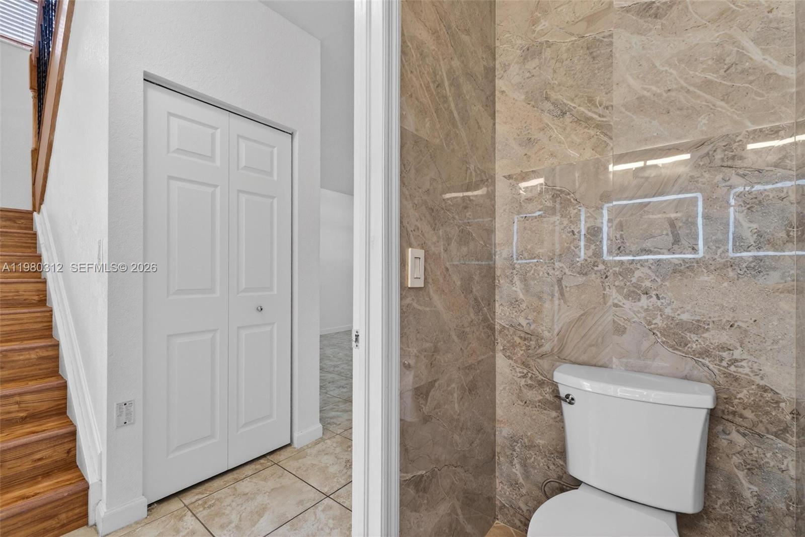 11561 Southwest 232nd Lane, Unit 11561 Homestead, FL 33032 - Photo 7 of 61 a bathroom with a toilet and a shower