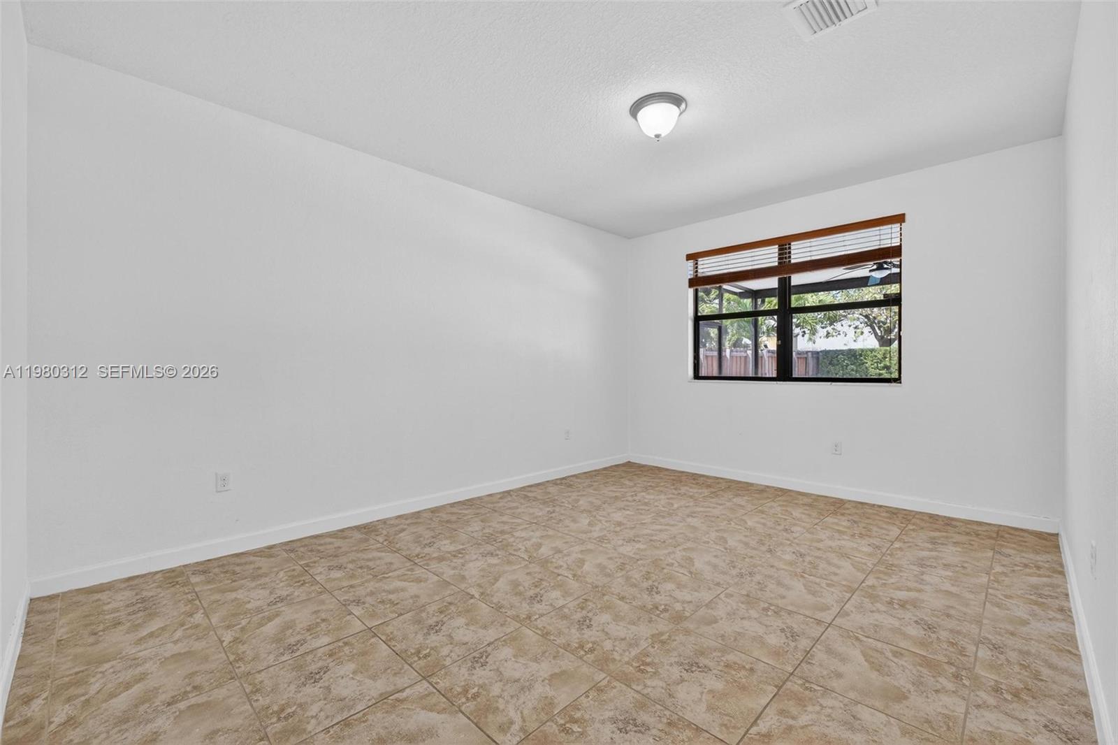11561 Southwest 232nd Lane, Unit 11561 Homestead, FL 33032 - Photo 10 of 61 an empty room with a window