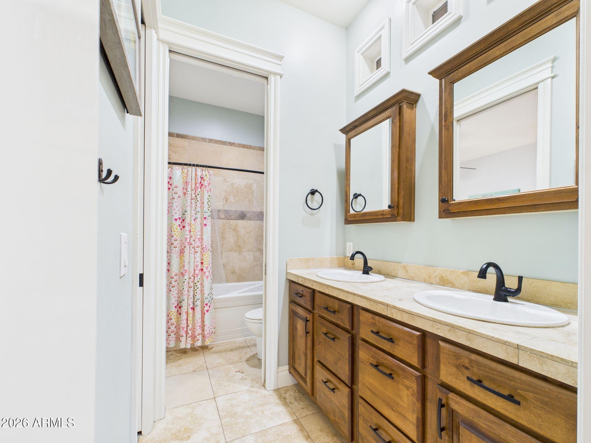 1006 West Rock Springs Circle Payson, AZ 85541 - Photo 19 of 35 a bathroom with a double vanity sink a mirror and a shower