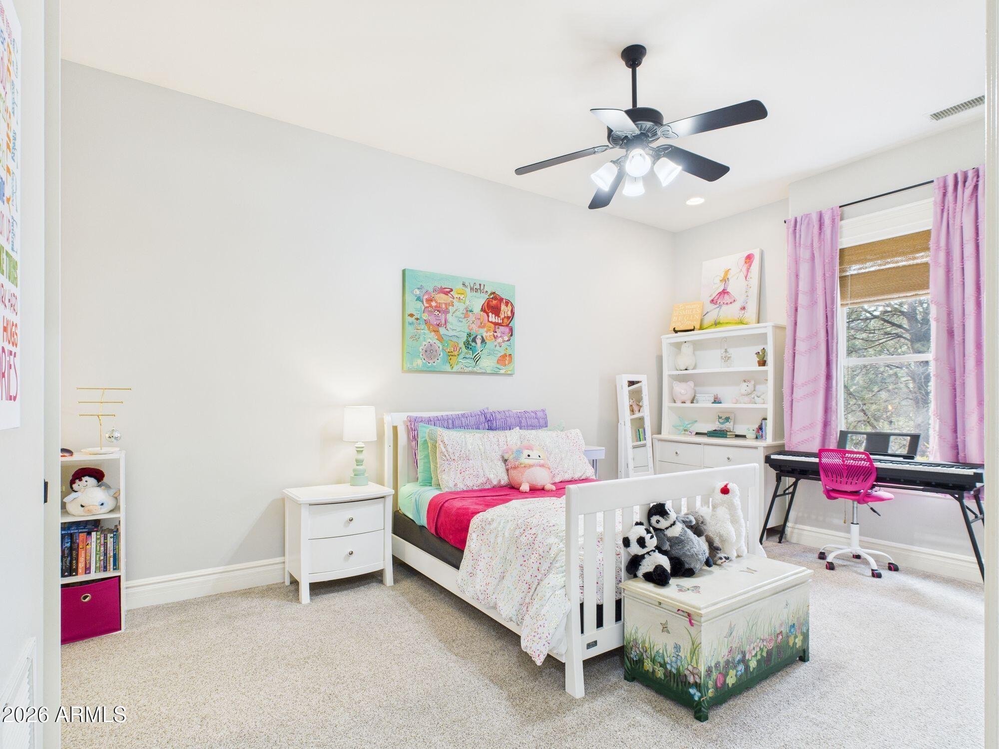 1006 West Rock Springs Circle Payson, AZ 85541 - Photo 20 of 35 a bedroom with a bed and a chandelier