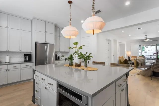 a kitchen with stainless steel appliances a white stove top oven a sink a counter space and cabinets