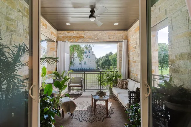 a kitchen with stainless steel appliances granite countertop a sink a stove a refrigerator a center island a dining table and chairs