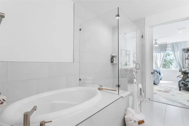a bathroom with a double vanity sink mirror and shower