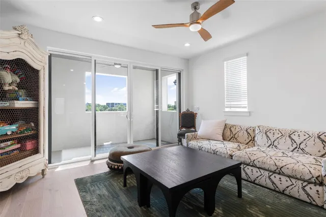 a living room with furniture a rug and a chandelier