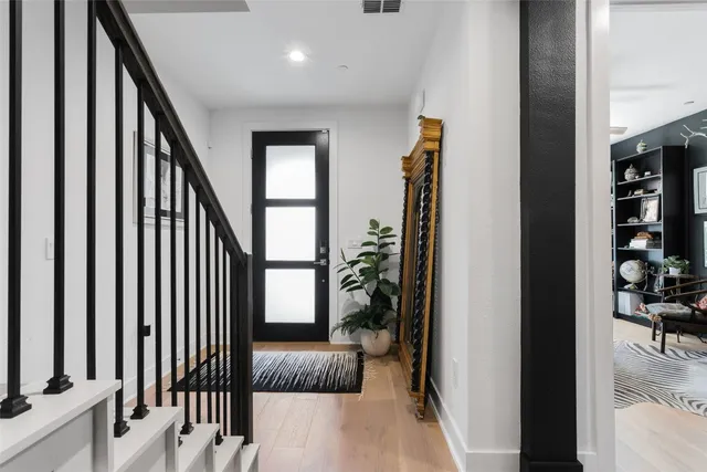 a view of entryway and hall with wooden floor