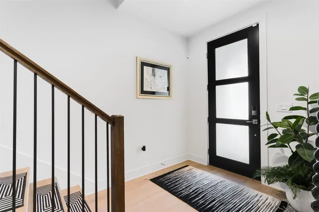 a view of a balcony with wooden floor and a potted plant