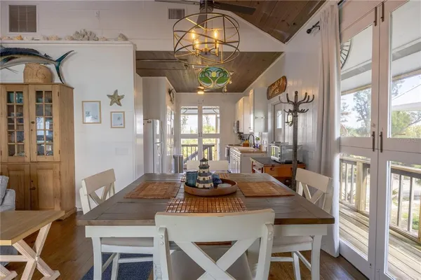 a open kitchen with stainless steel appliances granite countertop a refrigerator a sink dishwasher a stove and white countertops with wooden floor