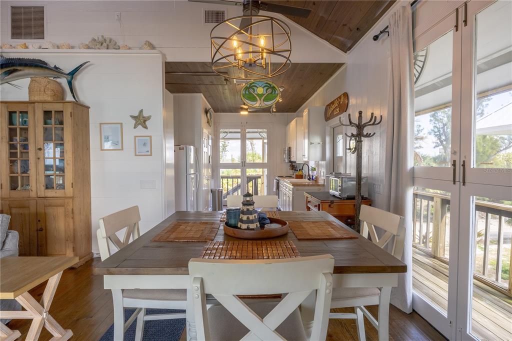 8796 Grand Avenue Boca Grande, FL 33921 - Photo 11 of 19 a dining room with furniture a chandelier and a rug