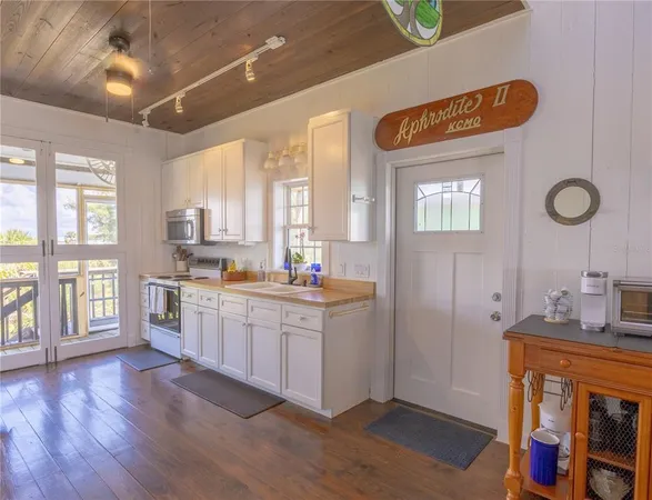 a white refrigerator freezer and a wooden floor