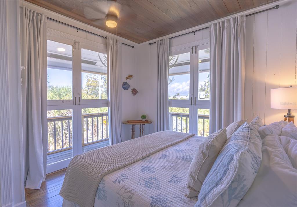 8796 Grand Avenue Boca Grande, FL 33921 - Photo 17 of 19 a bedroom with a large bed and a large window