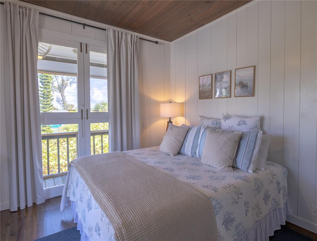 8796 Grand Avenue Boca Grande, FL 33921 - Photo 18 of 19 a bedroom with a large bed and a window