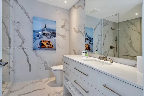 a bathroom with a sink toilet and shower