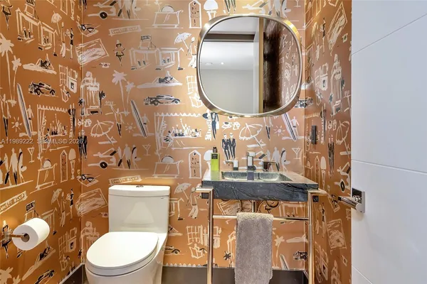 a bathroom with a toilet mirror and vanity
