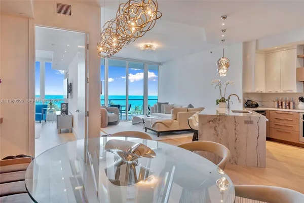 a living room with furniture and a chandelier