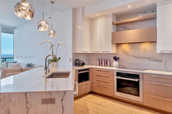 a kitchen with a stove oven and a sink